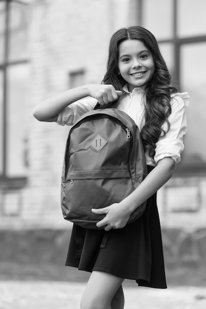 Back to School Essentials Ich brauche Glückliches Kind hält die Schultasche im Freien Kleines Kind trägt Uniform Zurück zur Schule Mode Formelle Bildung Startup 1. September Absolutes Muss