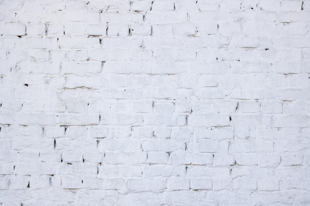 Backsteinmauer gemalter weißer Hintergrund oder Beschaffenheit