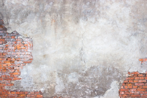 Foto backsteinmauer mit beschädigtem putz