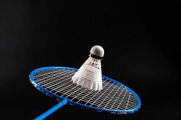 Badminton-Sportausrüstung auf dunklem schwarzem Hintergrund schließen