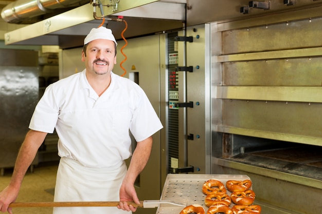 Bäcker in seiner Bäckerei Brot backen