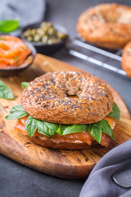 Bagels com salmão defumado, cream cheese e alcaparras em uma mesa. Comida, almoço, brunch, refeição no prato, conceito de placas