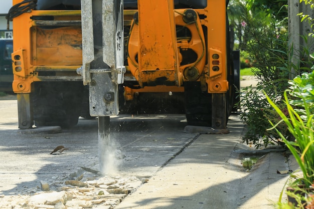 Bagger, der Betonstraße-Oberfläche bricht