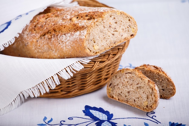 Baguette de cereales frescos sobre tela blanca