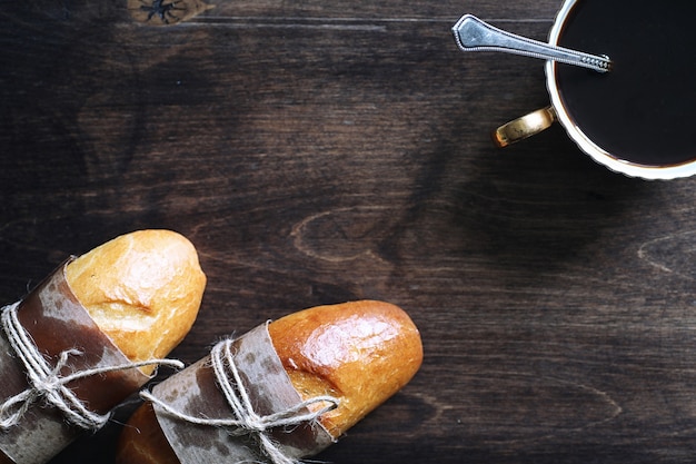 Baguette francés recién horneado en una mesa de madera para el desayuno