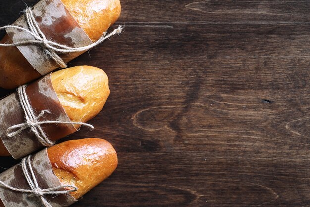 Baguette francés recién horneado sobre una mesa de madera para el desayuno