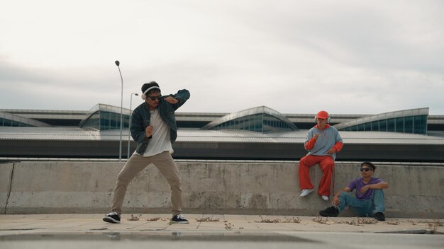 Foto el bailarín de break disfruta realizando movimientos de estilo libre con sus amigos alentando rápidamente