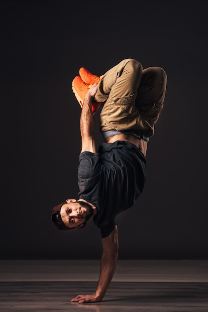 Un bailarín de hip hop o bboy se congela en una pose en la mano