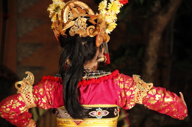 Una bailarina bailando danzas balinesas de espaldas