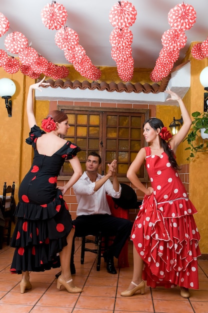 Foto bailarines de flamenco español durante la feria de sevilla bailando sevillanas