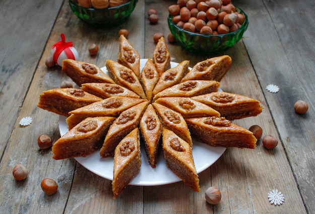 Baklava de cookies de férias tradicional azerbaijão na chapa branca sobre o rústico com nozes