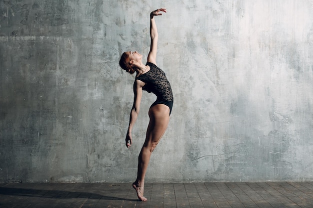 Ballerina weiblich. Junge schöne Ballettänzerin, gekleidet in professionellem Outfit, Spitzenschuhen und schwarzem Körper.