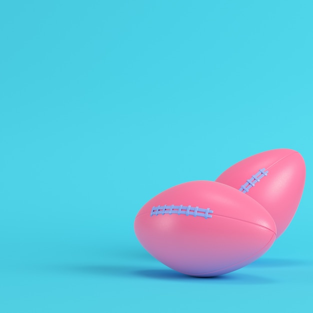 Balón de fútbol americano rosa sobre fondo azul brillante