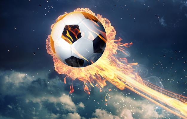 Foto balón de fútbol en llamas de fuego