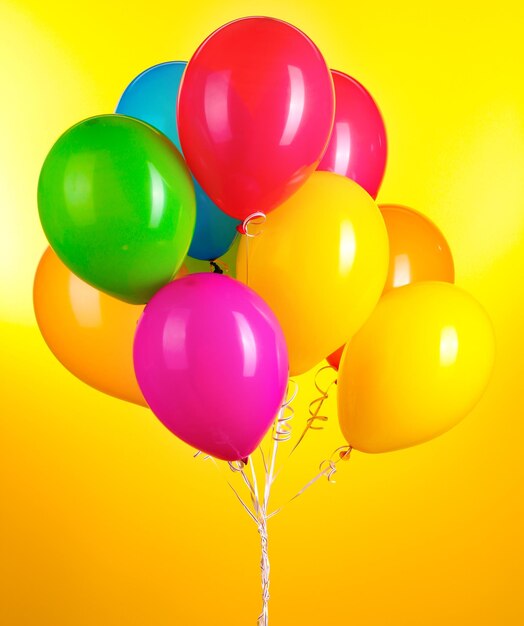 Balones de colores sobre un fondo amarillo