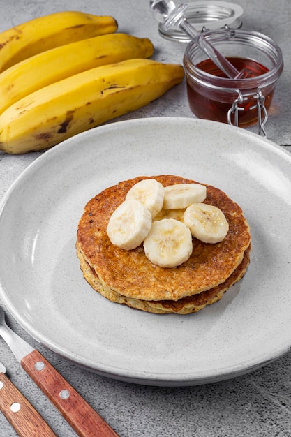 Bananen-Hafer-Pfannkuchen mit Bananenscheiben und Honig