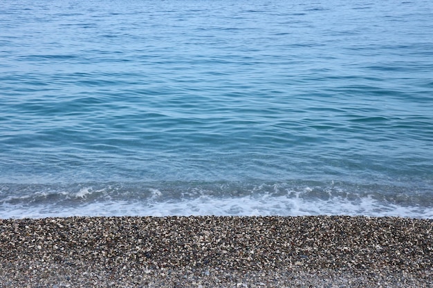 Banco de guijarros con el mar y la playa al fondo