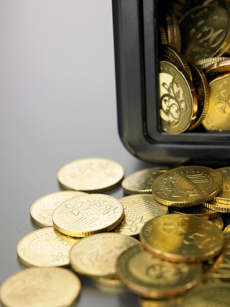 Banco de monedas en forma de caja fuerte en primer plano sobre fondo gris