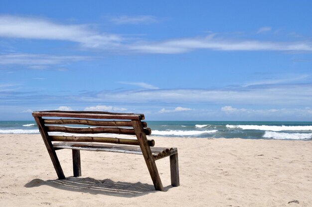 Foto un banco torcido en la playa