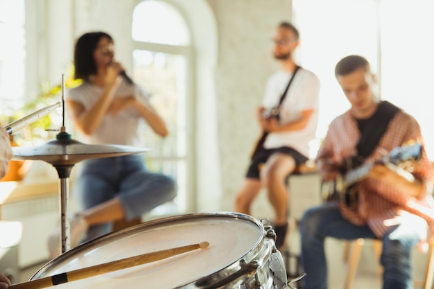 Foto banda de músicos tocando juntos no local de trabalho de arte com instrumentos