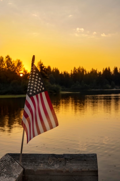 Bandeira americana no fundo do lago por do sol. Conceito de férias nos EUA