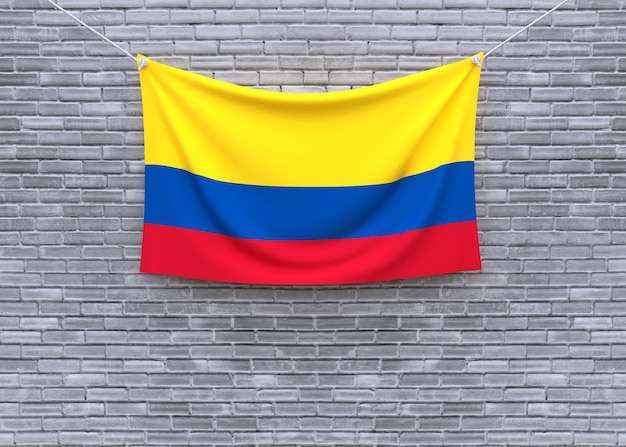 Bandeira da colômbia, pendurado na parede de tijolo