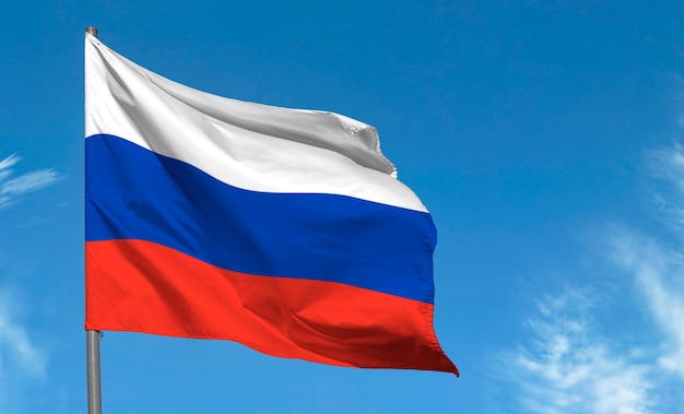 Bandeira da Rússia acenando contra o céu azul
