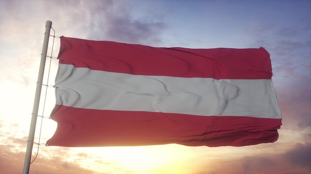 Bandeira da Áustria balançando ao vento, o céu e o sol de fundo. Renderização 3D.