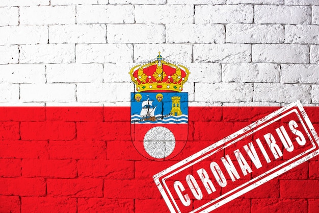 Bandeira das regiões ou comunidades da Espanha Cantabria com as proporções originais. carimbado de Coronavirus. textura da parede de tijolo. Conceito de vírus corona. À beira de uma pandemia COVID-19 ou 2019-nCoV