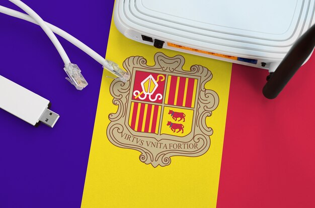 Bandeira de andorra, retratada na tabela com o cabo rj45 da internet, adaptador wifi usb sem fio e roteador. conceito de conexão à internet