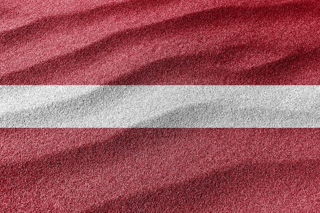 Bandeira de areia da Letônia, fundo de areia da bandeira nacional