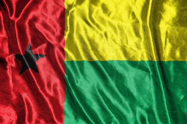 Bandeira de pano da Guiné-Bissau Bandeira de cetim Textura de tecido acenando da bandeira