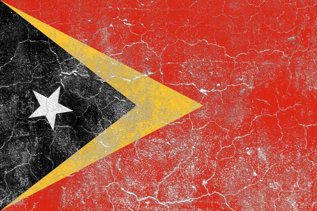 Bandeira de timor-leste em uma superfície de parede de concreto velha danificada