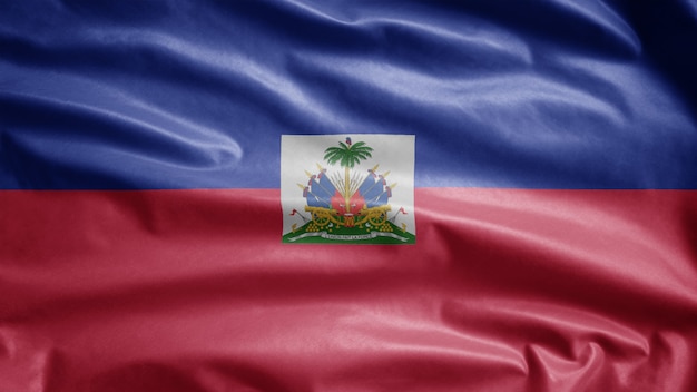 Bandeira do haiti balançando ao vento. perto da bandeira do haiti soprando seda lisa.