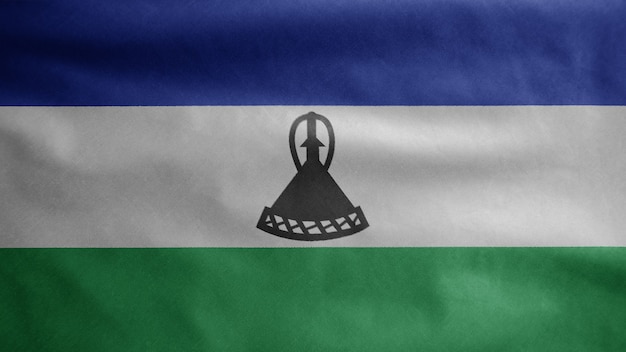 Bandeira do Lesoto balançando ao vento. Feche de Sesotho banner soprando, seda macia e suave. Fundo de estandarte de textura de tecido de pano. Use-o para o dia nacional e o conceito de ocasiões do país.