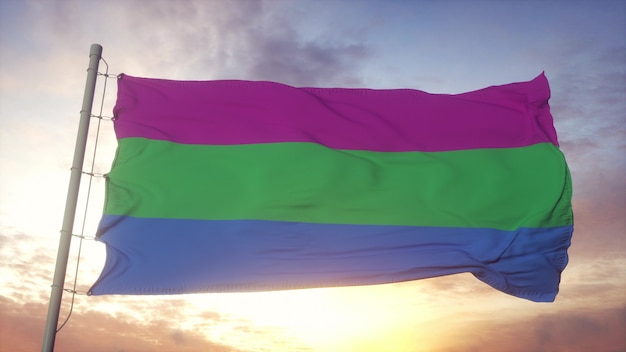 Bandeira do orgulho polsexualidade balançando ao vento, o céu e o sol de fundo. Renderização 3D.