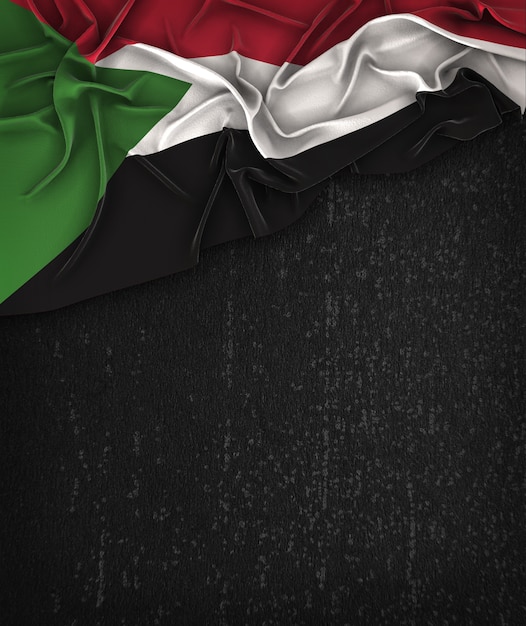 Bandeira do Sudão Vintage em um quadro preto do Grunge com espaço para o texto