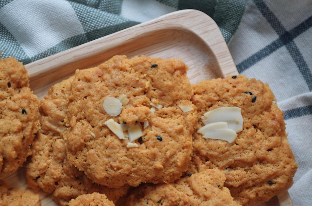 Una bandeja de madera de galletas de almendras sobre una mesa.