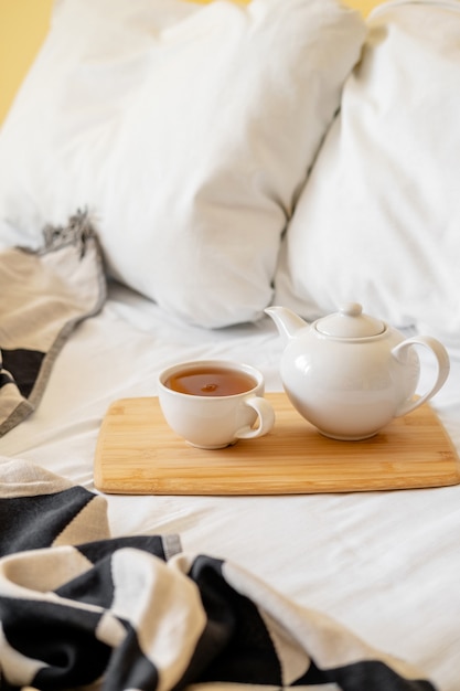 Bandeja de madera con taza de té y tetera