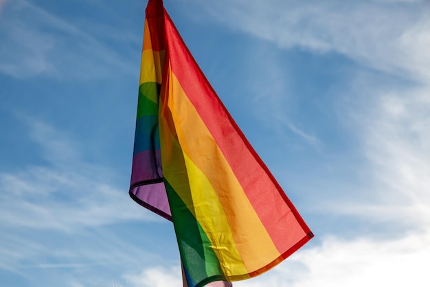 Bandera del arco iris contra un cielo azul. símbolo LGBT.