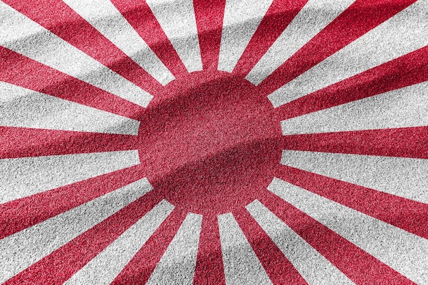 Foto bandera de arena del sol naciente, fondo de arena de la bandera nacional