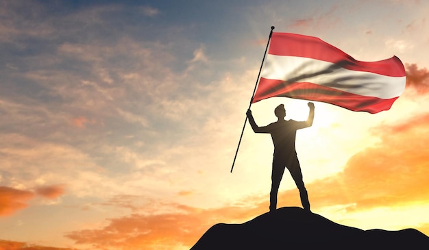 Bandera de Austria ondeada por un hombre que celebra el éxito en la cima de una montaña 3D Rendering