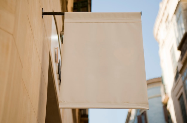 Bandera en blanco o banner textil colgado en la pared.