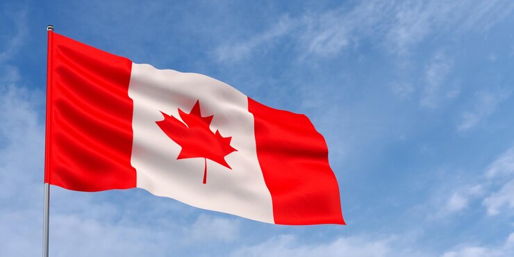 Foto bandera de canadá en asta de bandera sobre fondo de cielo azul bandera canadiense ondeando en el viento sobre un fondo de cielo con nubes lugar para ilustración de texto 3d