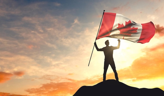 Bandera de Canadá ondeada por un hombre que celebra el éxito en la cima de una montaña 3D Rendering