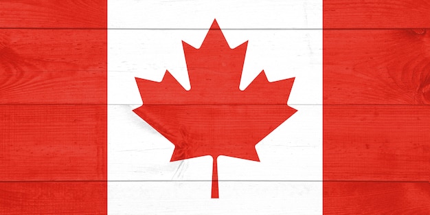 Bandera de Canadá pintada sobre fondo de tablón de madera sucio