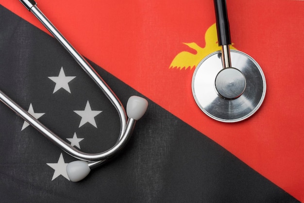 Bandera y estetoscopio de papua nueva guinea el concepto de medicina