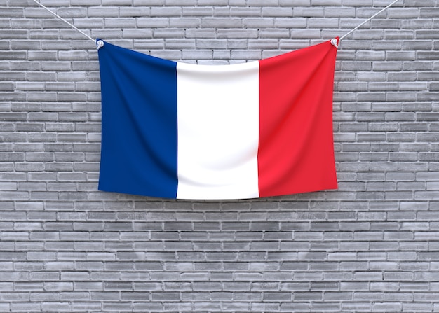 Bandera de Francia colgando en la pared de ladrillo