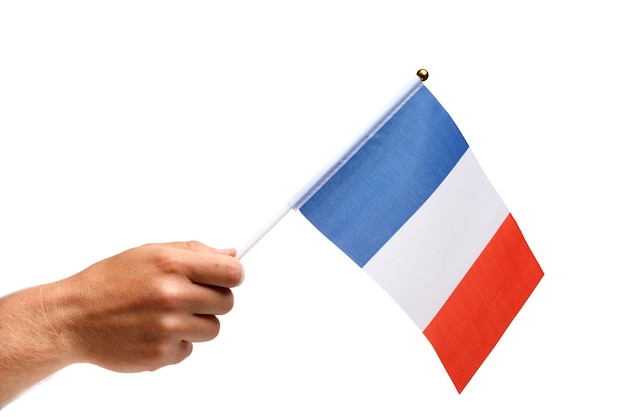 Bandera de Francia pequeña en mano aislar.