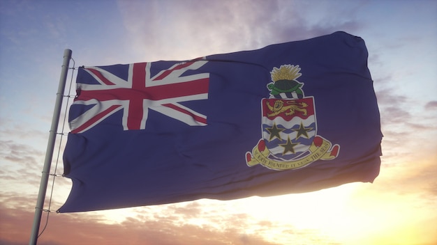 Bandera de las Islas Caimán ondeando en el viento, el cielo y el sol de fondo. Representación 3D.